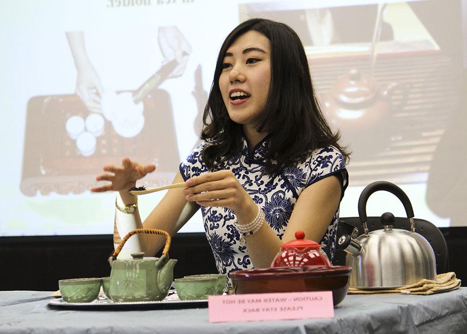 female student instructing how to do Chinese tea ceremony
